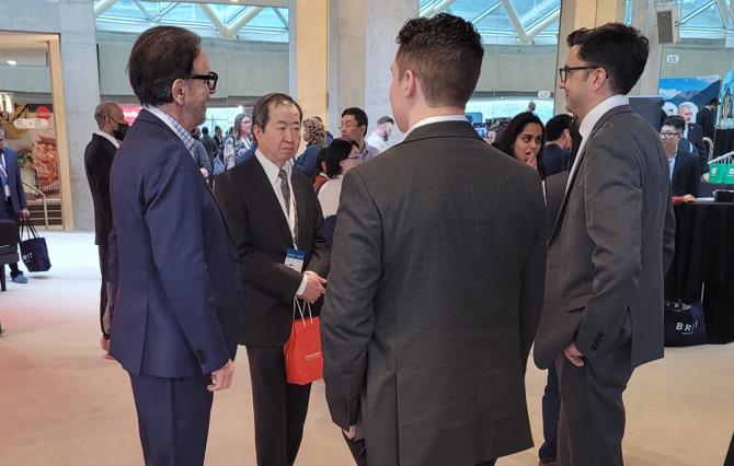 George Athanassakos speaking with Francis Chou, Luke Field, and Nico Mendoza
