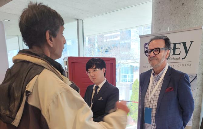 George Athanassakos and Bojian Wang chatting with Fairfax AGM attendee